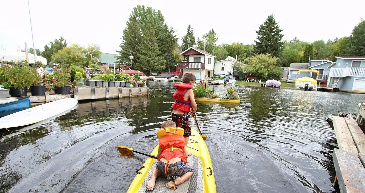 Kids on a paddle board in the lagoon canal, 2016