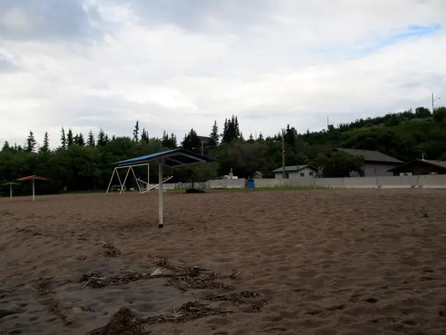 Sandy beach with shade shelters and playground